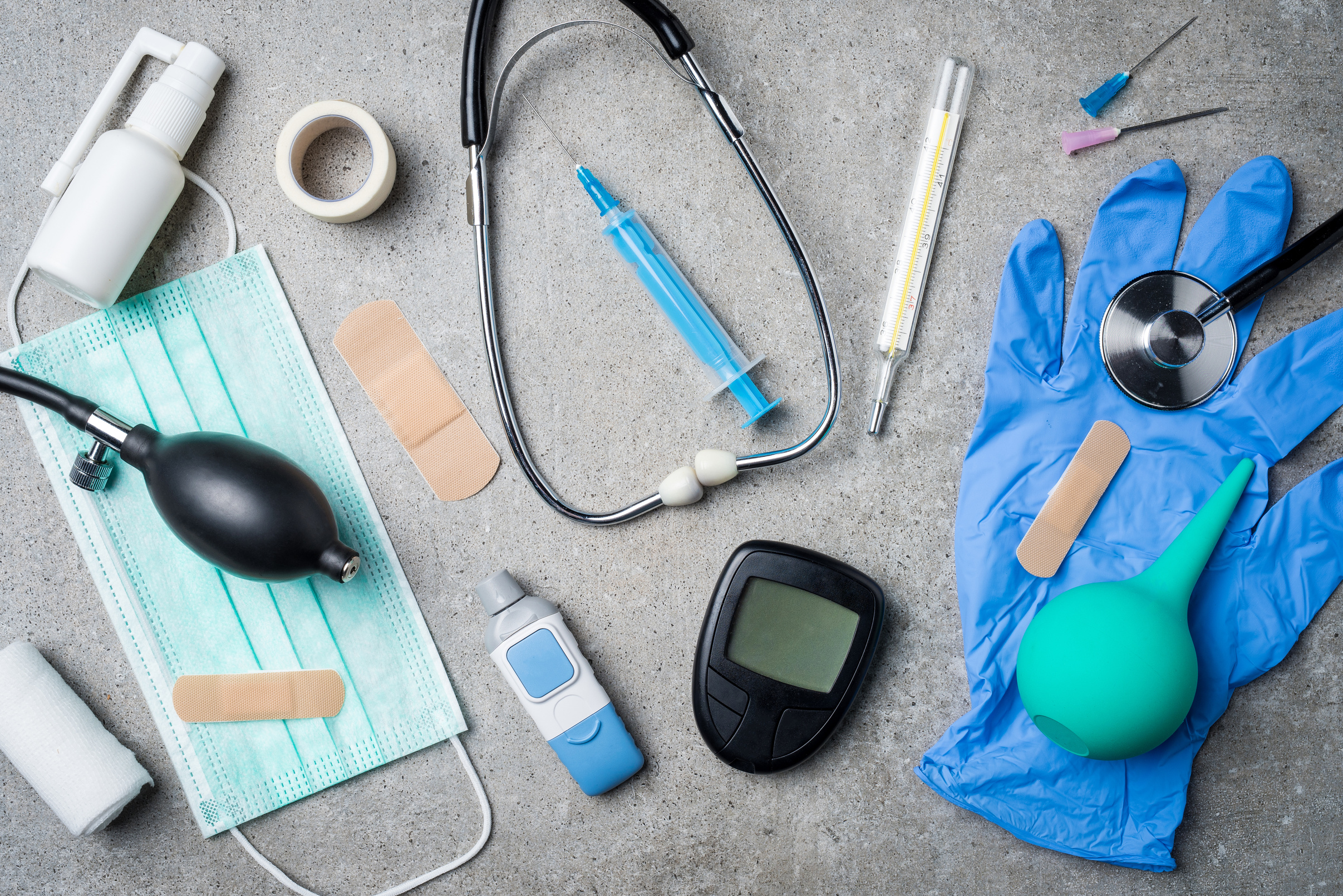 Medical equipment on gray stone background.